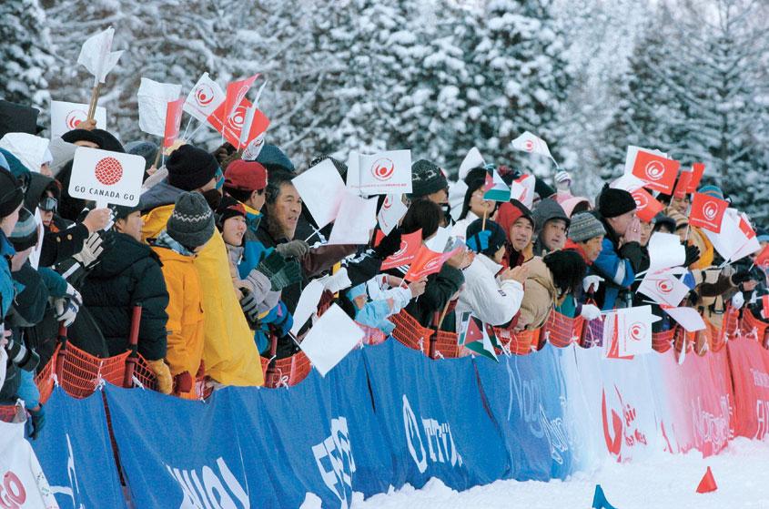 Spectators pack the snowshoeing venue to cheer the athletes. Shuttle buses carried them from the car park to the venue.