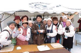 Her Imperial Highness Princess Takamado (C) is all smiles sharing a bowl of tonjiru soup (miso soup with pork and vegetables) served by members of the women's society in Mure Village.