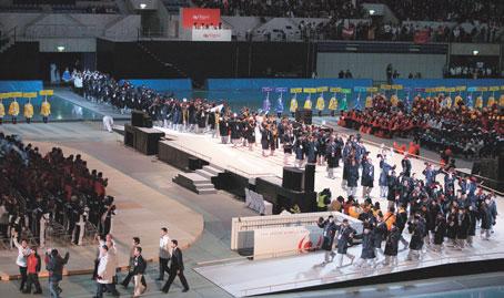 Led by a placard-holding girl scout, each delegation entered through the south gate of the arena.