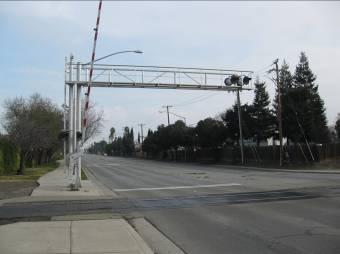 The at-grade crossing consists of a single track with 4 vehicle travel lanes. Vehicle crossing is controlled by gate controls and flashing warning lights. 13.