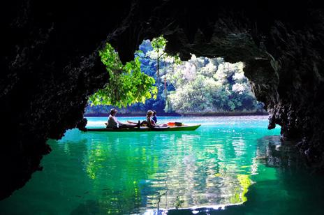 largely pristine limestone and volcanic islands, blanketed in emerald forest, surrounded by a shimmering turquoise