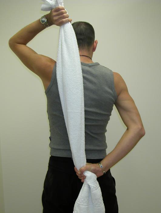Arm circles with weights Hold the towel behind your back, with