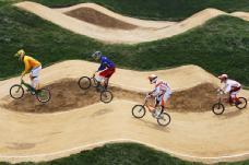 Bicycle Motocross (BMX) BMX Racing: The BMX racing is ridden on a dirt circuit. Riders start on an elevated start ramp and race over a track alternating bumps, banked corners and flat sections.
