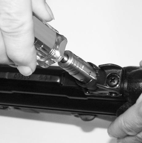 Elevation Adjustment 1. Insert elevation adjustment tool into the rear sight cylinder so that the wedges of the tool engage in the two splines in the cylinder which contains the catch bolts.