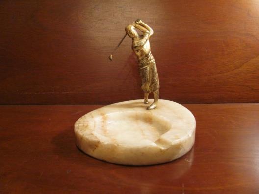 After Zwick, a white metal figurine of a golfer in a