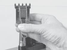 The clamping pressure applied to the string should be adjusted to provide sufficient pressure to secure the string when subjected to the desired pulling tension.