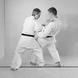 Do the unbalancing movement with your knee and arm so that the opponent is forced to bend backwards to an awkward