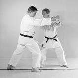 three points: the right wrist; the inner side of the right knee; and the chin of the opponent.
