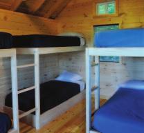 The cabins have two bedrooms, living room, dining area, kitchen, bathroom, shower, cable, DVD, Wi-Fi, ADA compliant and are on one floor.