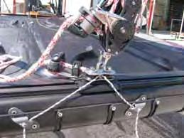 Take the mainsheet assembly (already mounted) from the rigging bag and attach the snap hook to the