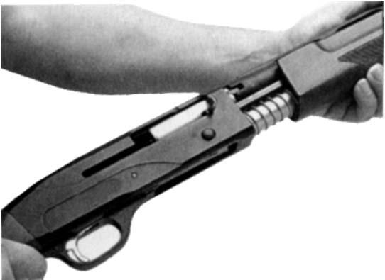 Lock the bolt open by pressing the but- ton located toward the front of the receiver (figure 13).