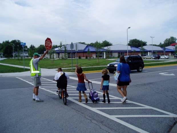 The provision of crossing guards helps to promote the healthy pattern of children walking to school.
