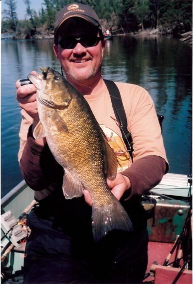 The two smallies below were just a few of the 80 plus smallies that I caught one day on your olive and black jigs! Ed and I had at least 14 doubles that day. We figure we caught over 130 fish.
