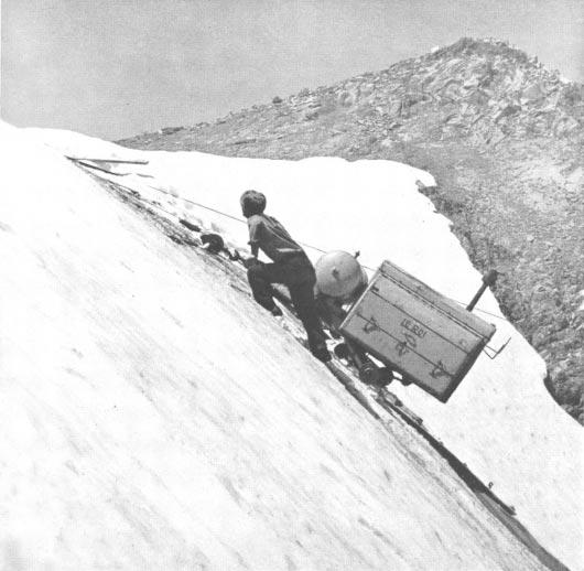 SQUAW VALLEY, CALIFORNIA. Heavy compresser was mounted on toboggan and winched to summit by work crews. SQUAW VALLEY, CALIFORNIA. Mr.