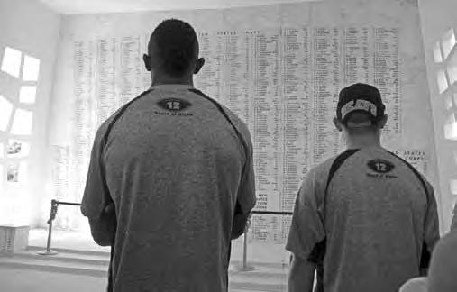 Oregon State players pause for reflection at Pearl Harbor s USS Arizona Memorial during activities at the 2013 Hawai i Bowl.