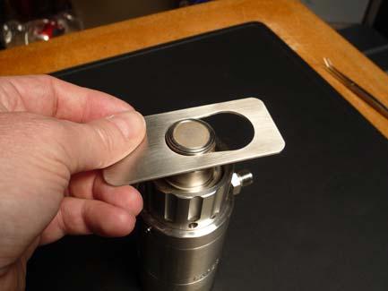 Place the larger section of the tool over the ring and pull to tool until it is tight around the rings middle section.