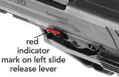 With the left hand. press the slide release axle from the right to the left until the red isidciatr is showing (Figure 18).