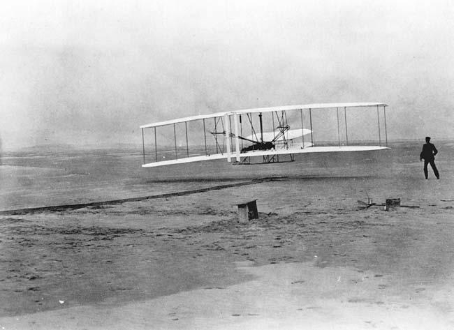 46 P. N. Johnson-Laird Fig. 4 The flyer just after take off on its first flight, December 17 th 1903. Orville is lying on the wing at the controls; Wilbur is to the right of the machine.