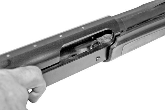 Push up to three (3) 2¾ or 3 shotshells of the correct gauge, one at a time, past feed latch into the magazine tube, ensuring the rim of each shell engages the feed latch and is held inside the