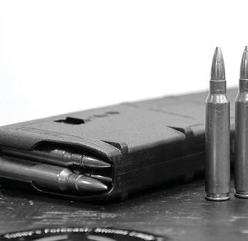 1. Use only ammunition for which your rifle is chambered. 2. With the front of the magazine pointing forward, place a round between the lips (bullet facing forward).