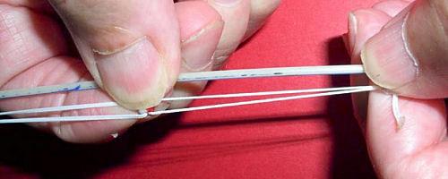 adjust the tension line, firmly hold one loop and slide the bead to either lengthen the tension