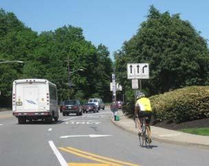 While mature shade trees provide a nice buffer from the roadway, the trees create vertical clearance issues. In addition, there are no intersection treatments. Section 1b.
