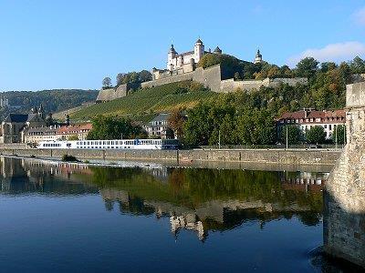 Enjy the charm f this twn that is lcated amng vineyards at the Main-riverside, and experience the rmantic wine taverns. Yur vernight stay is in Würzburg.