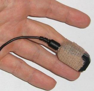 Note: Place the sensor label up, so that the electronic sensor components (the two small square openings) on the back of the sensor (not shown) are against the finger.