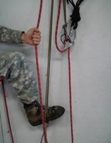 An alternate technique is to do the above procedure, but place a foot in and step down on the cord or sling material rather than clipping it into the harness.