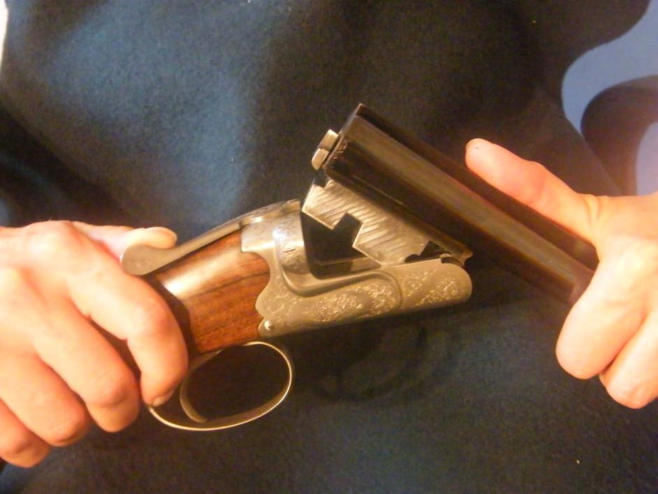 The barrels are attached to the action by grasping the stock grip with the firing hand and supporting the buttstock in between the firing elbow and body (see figure 8).