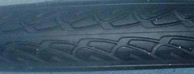 Direction of rotation for the tires can be determined by looking at the tread. All treads have some form of arrow contour to them. The arrow is always pointing in the direction of rotation.