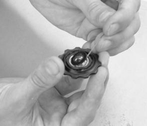 Clean all parts carefully and give the bearings a spin to make sure they run smoothly. If not, remove the black rubber seal from one side of the bearing (Fig.