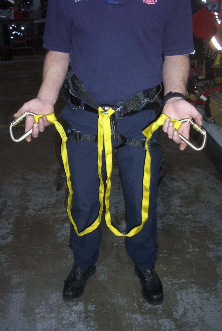 As the rescuer climbs, he/she ensures that one of the carabiners is at all times connected either directly over a smaller diameter structurally significant object (such as a ladder rung), or with the