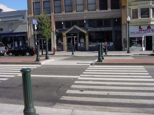 They are trapezoidal in shape on both sides and have a flat top where the pedestrians cross.