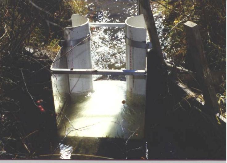 The pre-fabricated S-M flume can also be installed in unlined channels as shown in figure 16. Figure 16. S-M flume installed in an acequia in Santa Fe, NM. (Samani, 2005).