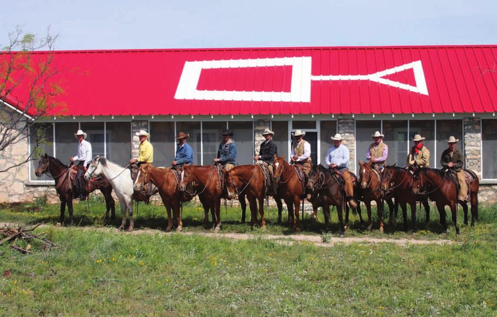 Spade Ranches employees lined up in front of the bunkhouse at Renderbrook Spade. Note the spade brand on the left shoulders of most of the horses.