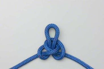 Butterfly knot a knot used to make a loop in a piece of one inch tubular webbing to tie an upper body harness or transfer equipment to a higher or lower location.
