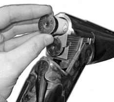Point the muzzle downward and in a safe position. Set the safety to SAFE (Figure 18). Move the release lever to the right and open the action (Fig. 17). Place a shell into each chamber (Figure 19).