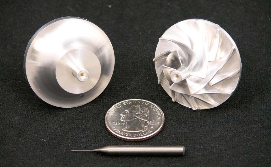 Figure 3-2: Nine S-CO 2 compressor wheels have been fabricated. This image shows the compressor wheel blank, the finished wheel, and one of the tools (not the smallest) used to machine the wheel. 3.1.