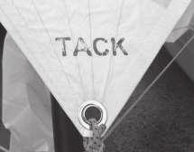 Thread the gennaker tack line through the cam cleat positioned on the port side of the mast ball and