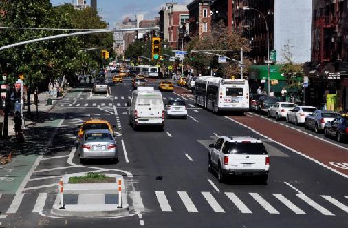 BACKGROUND Protected bike lanes and Select Bus Service lanes on 1st Avenue in the East Village.