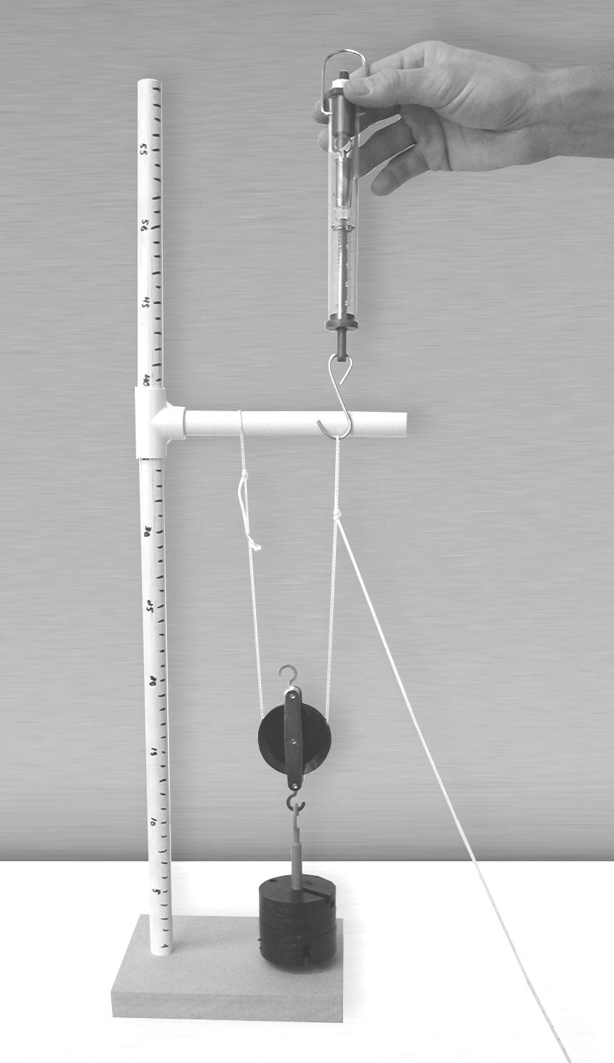 Place the hook of the spring scale in this loop. 8. Using the spring scale, the pulley cord, and the pulley, raise the hanging mass to a height 25 cm above the base of the pulley stand.