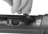 Press the rear trigger casing stud from both sides and withdraw it from
