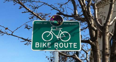 Bicycle Route signage may include City specific logos. See design example below.