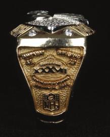 The fourteen-karat yellow gold ring incorporates the Vince Lombardi Super Bowl Trophy, an original Tiffany design featuring a football in kicking position, which the company has produced for every