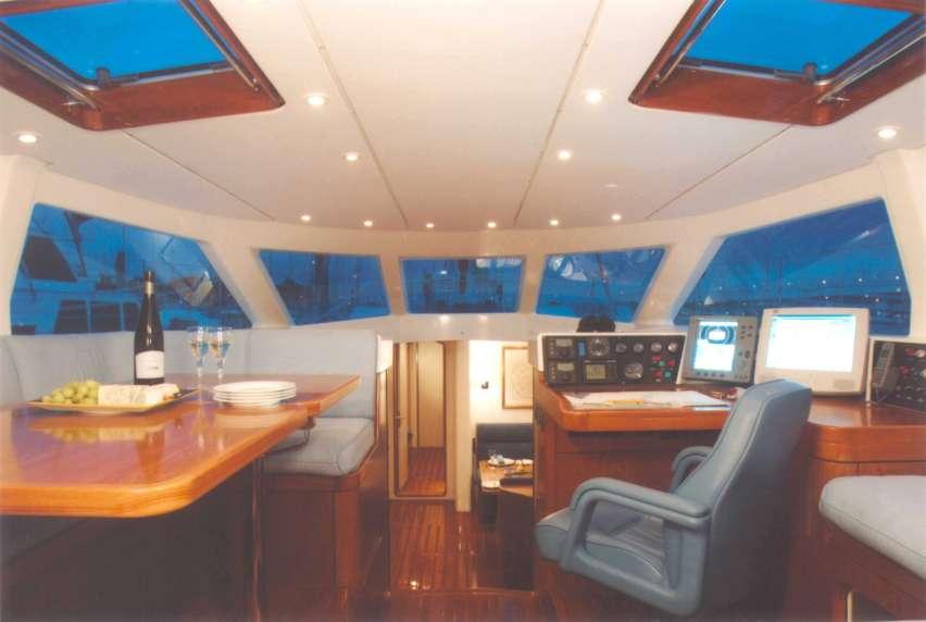 THE ELEVATED PILOTHOUSE MAKES A GREAT DINING LOCATION, AND A LARGE CHART TABLE AND CONNING STATION IS TO STARBOARD, ALL WITH WONDERFUL VIEWS OUT THE LARGE WINDOWS.