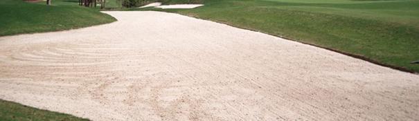 Bunkers A bunker is an area on the golf course that is filled with sand. Grass or a tree inside a bunker is not part of bunker. A wall or lip not covered with grass is in the bunker.