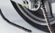 When new chain goes completely around the front sprocket and out under the swingarm, disconnect the old chain and pull both ends together under the center of the