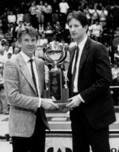 5 WCC Commissioner Michael Gilleran presents head coach Paul Westhead the 1988-89 WCC Championship trophy. It was the second straight conference tournament title for the Lions.