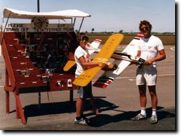 A couple more photos from Bob. Paul, This picture I just found, it would of been taken in 1976 or 1977. That is my son who is holding my first RC plane, a De Bolt Champion with an OS.